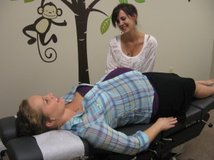 Photo of Dr. Kimberly Dawes working on a pregnant woman
